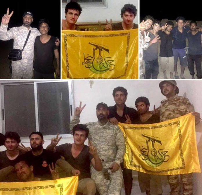 Освобожденные бойцы на фоне флага "Харакат аль-Нуяба"